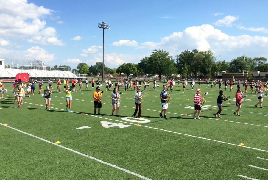 The band practices their drills on the field!