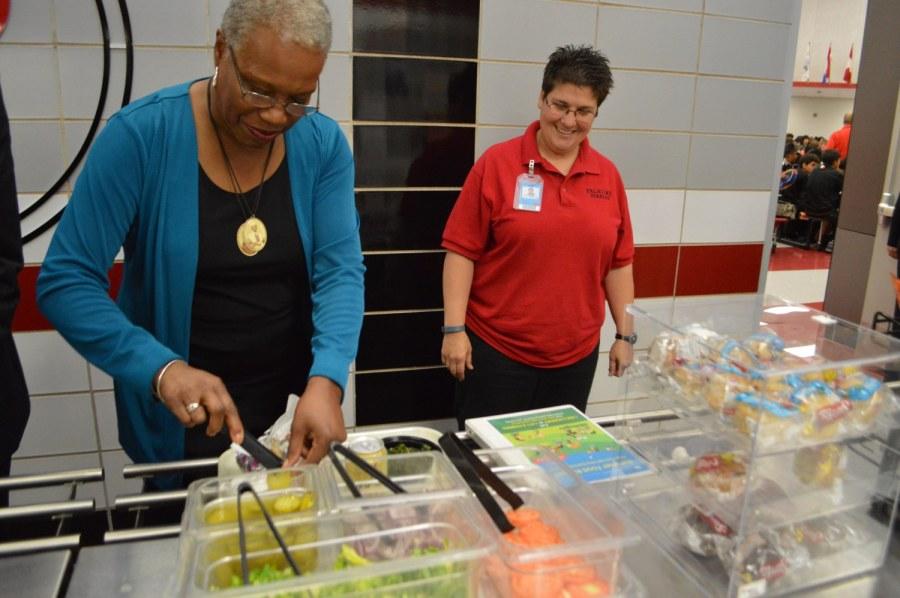 USDA Represenative Audrey Rowe selects toppings from the lunch line.