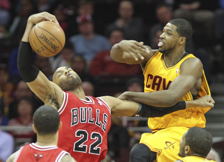 The Cleveland Cavaliers Tristan Thompson, right, is pushed aside by the Chicago Bulls Taj Gibson (22) while fighting for a first-quarter rebound at Quicken Loans Arena in Cleveland on Wednesday, Jan. 22, 2014. Chicago won, 98-87.