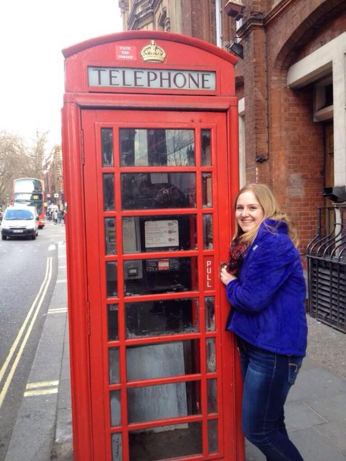 Senior Katie Hake posing by a telephone booth in London, England.