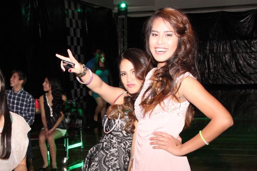 Two girls smile for the cameras as they hang out at turnabout.