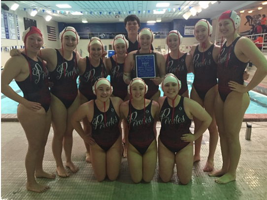 The girls' water polo team poses after winning a tournament.