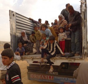 Syrian Kurdish refugees, carrying whatever they can, were still arriving in Turkey by the hundreds October 2, 2014 from Kobane, now under siege by Islamic extremists. Trucked in from the border, theyre about to board minibuses to take them to temporary refuge. 