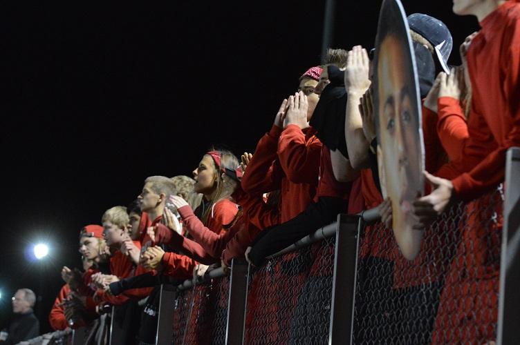 Seniors and varsity club members cheer on the varsity football team during the game against Fremd on Oct. 2.