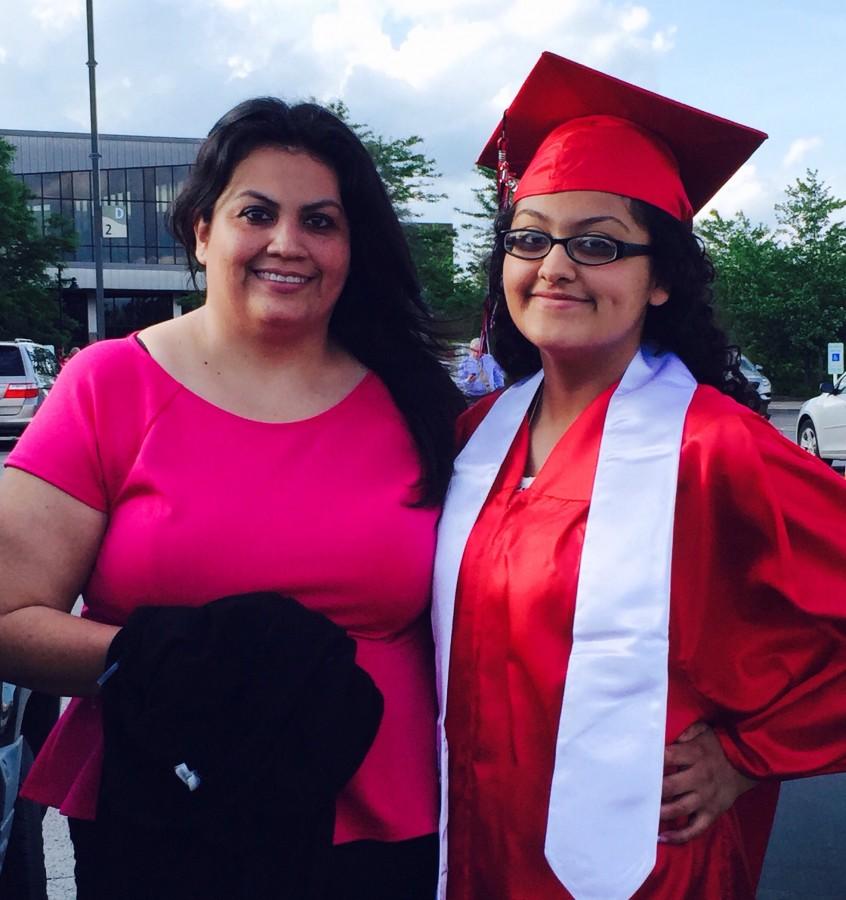 Kelly Torres with her mother moments after receiving her high school diploma. 