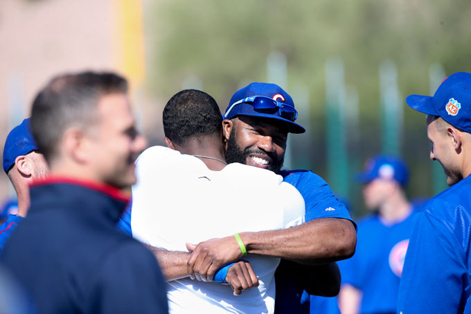 Chicago Cubs outfield Jason Heyward hugs Dexter Fowler after Fowler made a surprise appearance during Cubs spring training at Sloan Park in Mesa, Ariz., on Thursday, Feb. 25, 2016. Fowler has agreed to a one-year contract with a mutual option with the Cubs. 