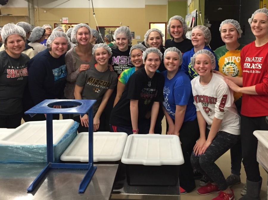 Service Club smiles after finishing their session at Feed My Starving Children, a nonprofit organization dedicated to ending worldwide hunger.