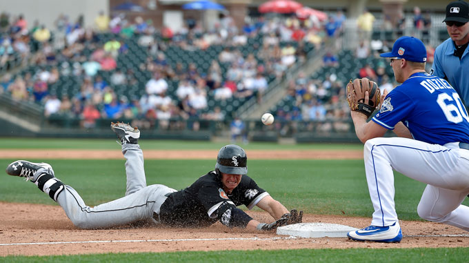 The Chicago White Sox's Rob Brantly reaches third before the throw to Kansas City Royals third baseman Hunter Dozier, right, on a triple in the sixth inning on Saturday, March 5, 2016, in Surprise, Ariz. The White Sox won, 7-6.
