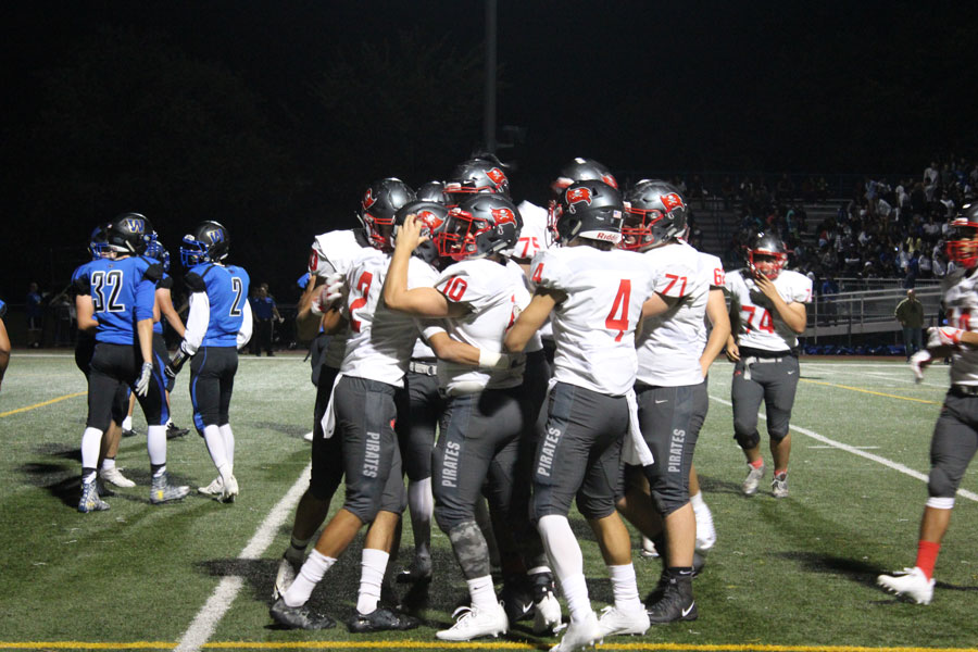 The Pirates celebrate during a blowout win against Rolling Meadows.
