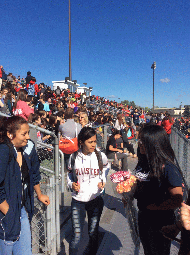 Students evacuate from Palatine High School to the Chic Anderson Stadium.