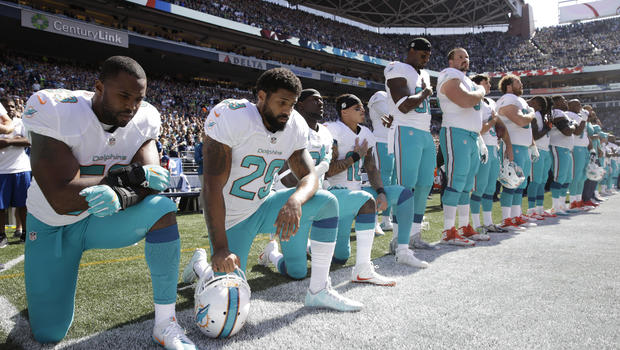 Players from the Miami Dolphins taking a knee during the National Anthem on Sept. 11, 2016.