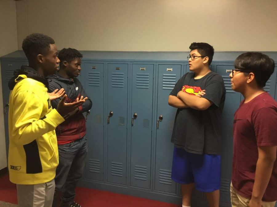 Seniors Demareon Collins and Marshawn Rayford give advice to Adam Ramos and Rafael Hernandez-Garcia .