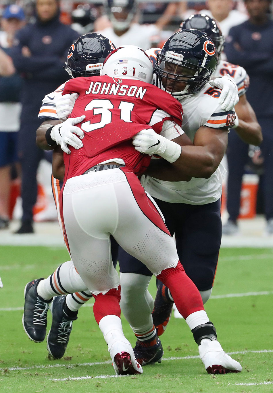 Chicago Bears linebackers Khalil Mack (52), right, and Danny Trevathan (59) tackle Arizona Cardinals running back David Johnson (31) in the first quarter on September 23, 2018, at State Farm Stadium in Glendale, Ariz.