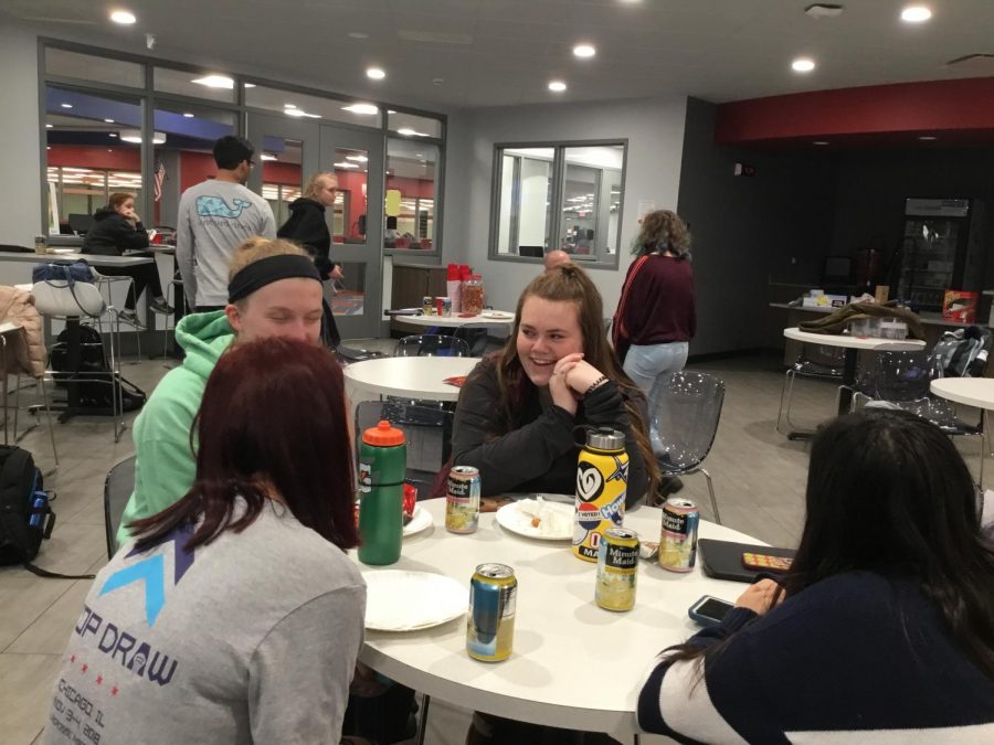 (From left) Jane Spencer, Haley Holz, Caroline Philbin, and Fidan Malikova talking at a Cutlass meeting. 