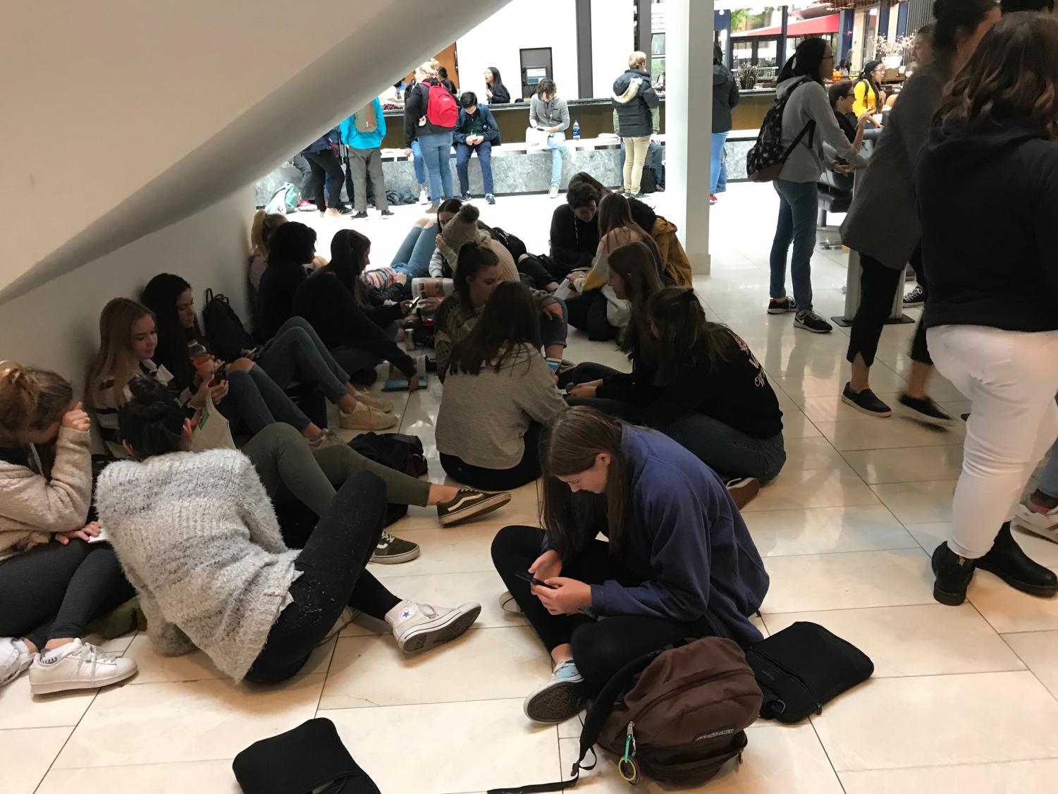 Students relaxing under the Hyatt Regency stairs at JEA/NSPA National High School Journalism Convention