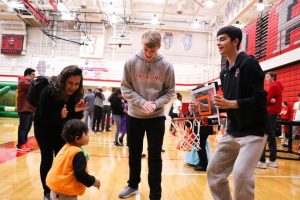 Palatines basketball team plays with trick or treaters during the annual PHS Hallween festival.