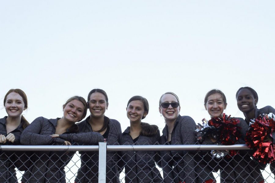 Perkovich (pictured 3rd from the right) stands smiling with her teammates for a picture.