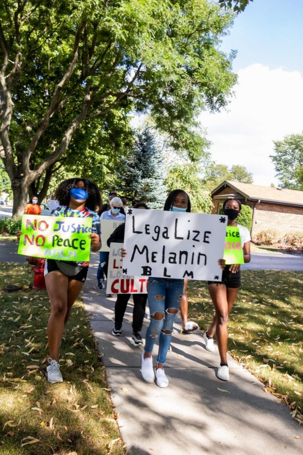Students march with signs at August protest