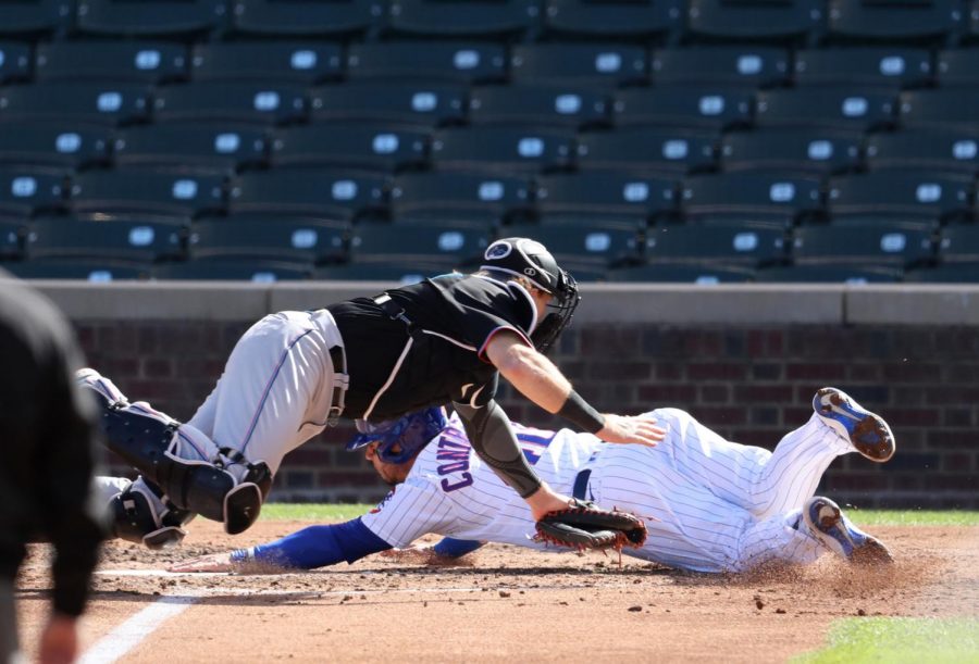 Miami Marlins catcher Chad Wallach tags out Chicago Cubs baserunner Willson Contreras, right, at home plate in the fourth inning of Game 2 of the National League Wild Card series at Wrigley Field in Chicago on Friday, Oct. 2, 2020. The Marlins advanced with a 2-0 victory.