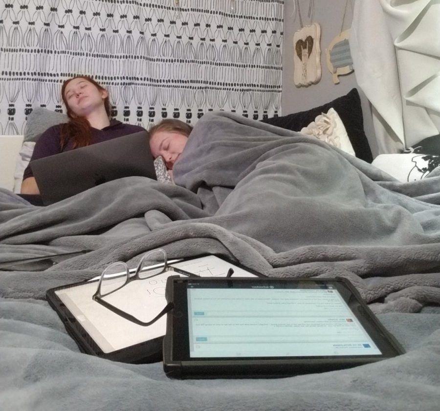 Junior+Hannah+Henrikson+and+senior+Emma+Langer+take+a+quick+nap+in+between+Zoom+classes.