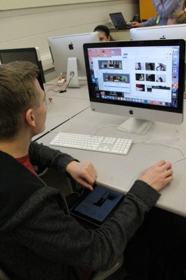 A PHS student using two screens to complete an assignment in 2017. With online learning, screen times have only increased.