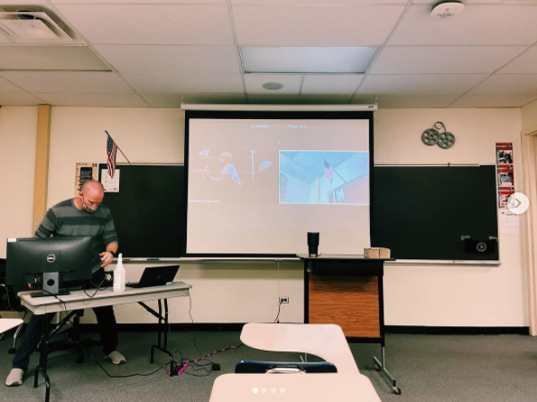 D211 plans to begin hybrid Dec 7 until winter break. English teacher Sean Berleman set up his work station for hybrid classroom.