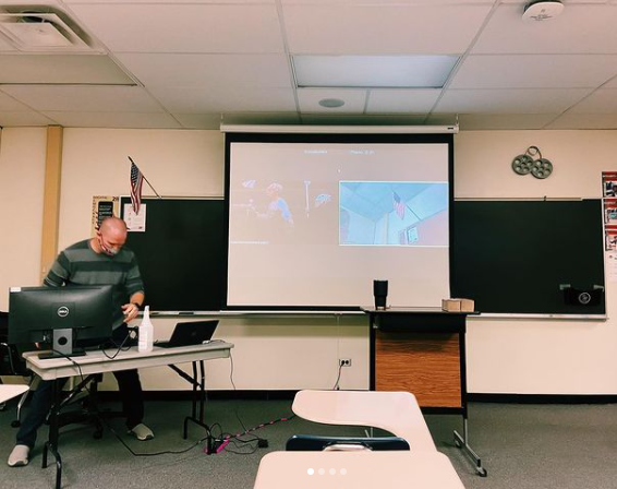 English teacher Sean Berleman takes attendance for students in person and Zoom.