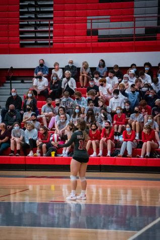 Junior Brianna Squeo serves in front of the student section. The students came out in full support against PHS’s crosstown rival. The theme was “whiteout”.