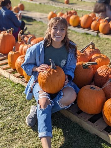 Palatine graduate Jes DeRamos gets ready for Halloween at the pumpkin patch.