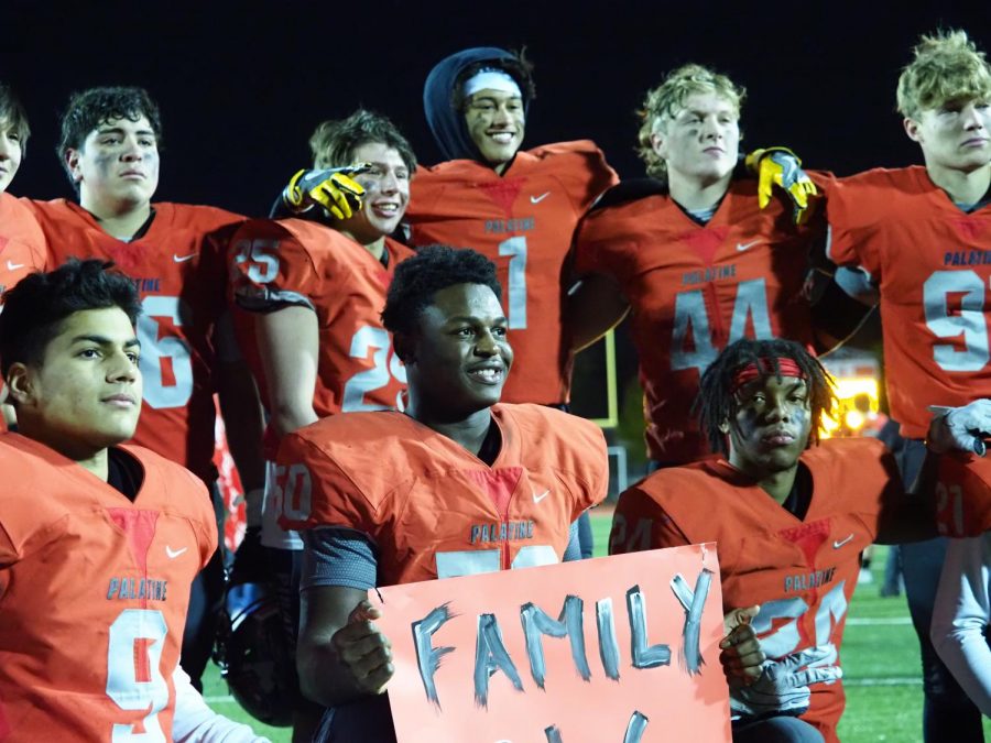 “The whole season the team talked about love, and how love is the biggest driving force for a team,” Bostick said, pictured gathered with the PHS football seniors.