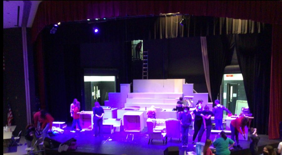 The musical cast on stage, preparing to run through the entire musical to practice. 