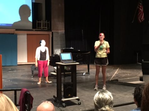 Melissa Meagher juggling on stage during a computer science fieldtrip.