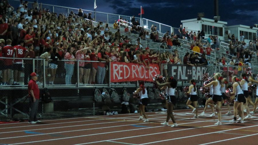 The PHS student section roars as they cheer on the football team with railings decorated by the schoools varsity club, the Red Ryders.