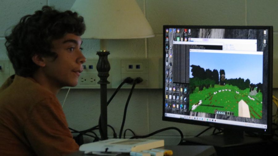 Senior computer club member Nolan Pena mans the Minecraft server as players compete in the games version of Hunger Games.