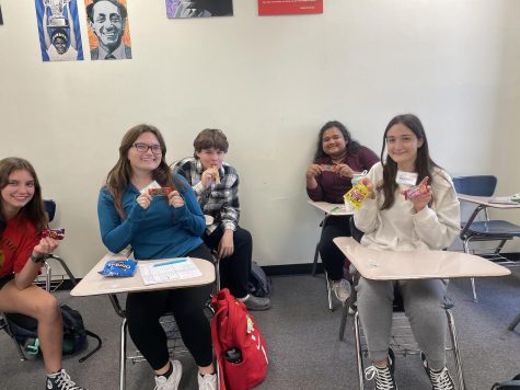 Students pose with candy from different Latinx countries to celebrate Latinx heritage month. 