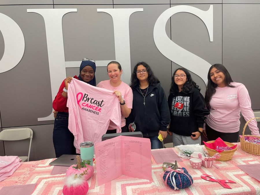 Staff and students sell Pink Out! gear during lunch periods in the cafeteria.