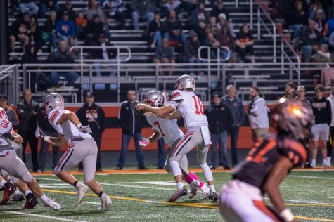 Junior QB Tommy Elter hands the ball off to Dominick Ball (Jr. 7). Elter had to step in to take Grant Dersnahs (Sr. 8) place after a season ending leg injury. 