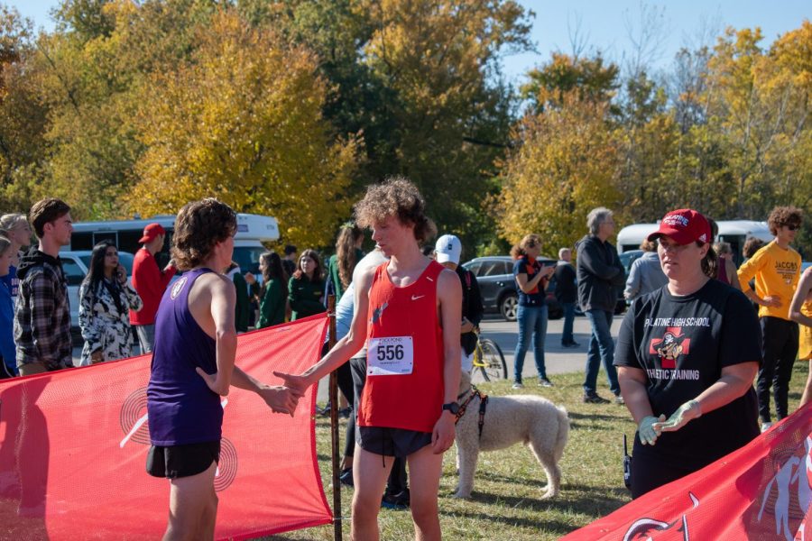 Mason Krieg demonstrates sportsmanship and shakes the hand of a competitor after the race.