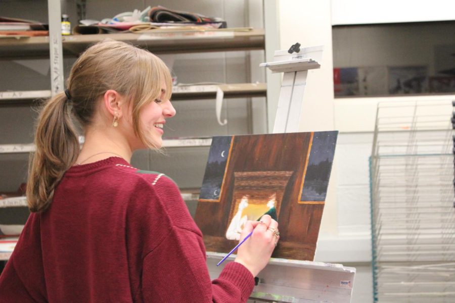 Senior AP art student Anna Martino paints in the art studio. 