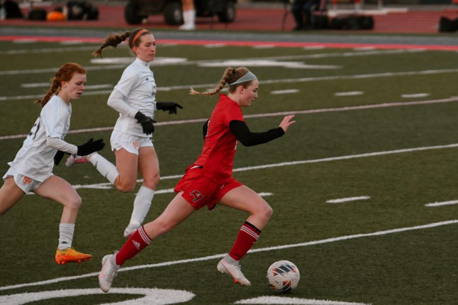 Freshman Jolee Waddington (#5) running with the ball as she successfully takes it from Hersey. 