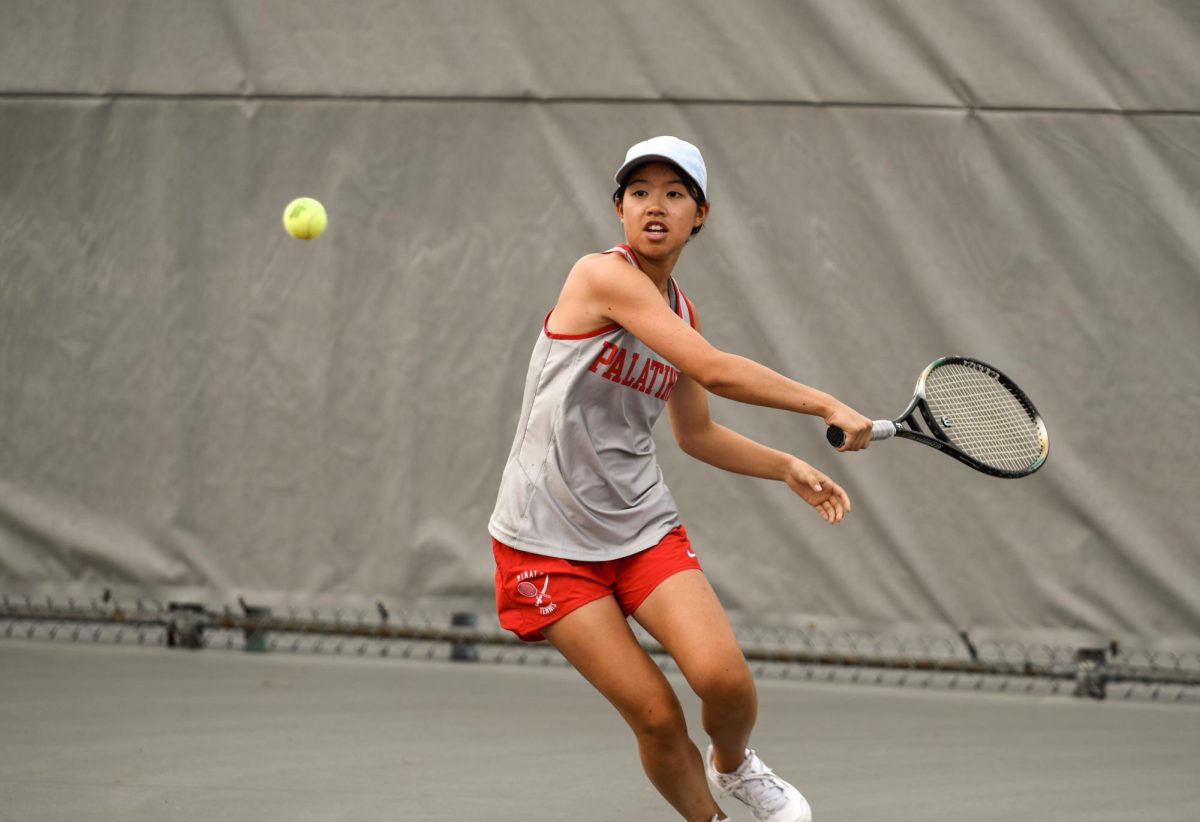 Junior Grace Wang striking the tennis ball.