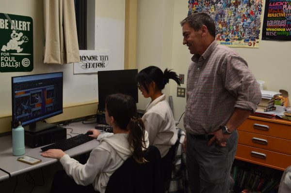 Mr. Paul assists students at Yearbook Club as they work to meet deadlines by creating new spreads.