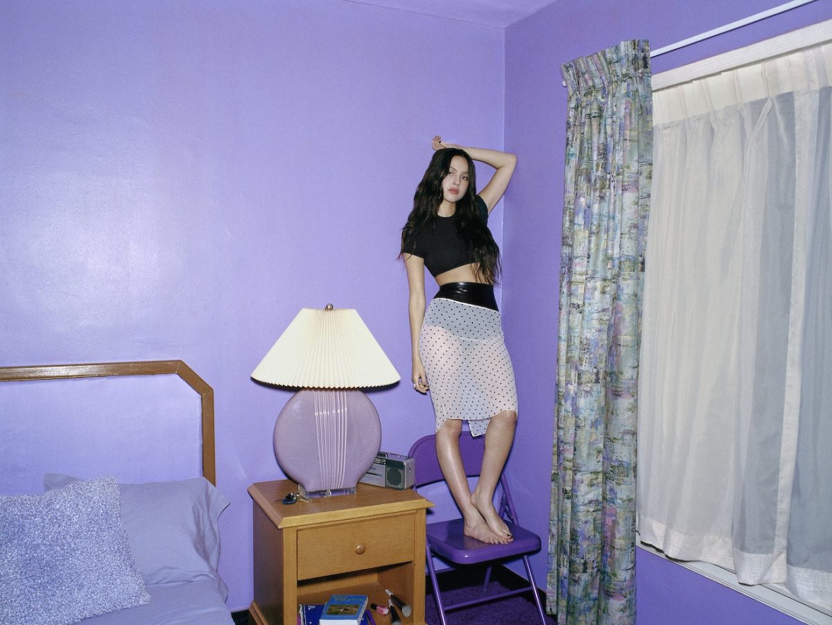 Olivia+Rodrigo+poses+in+a+purple+filled+room+that+emulates+her+sophomore+album+%E2%80%98Guts%E2%80%99