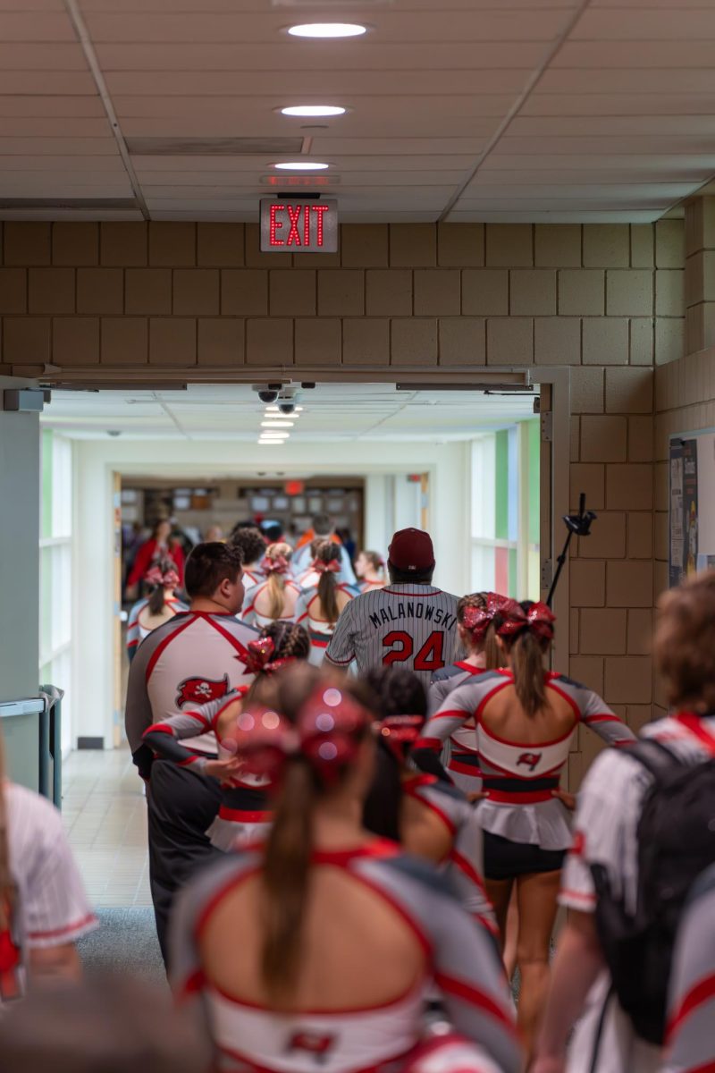 The team walking down the hallway before their routine starts