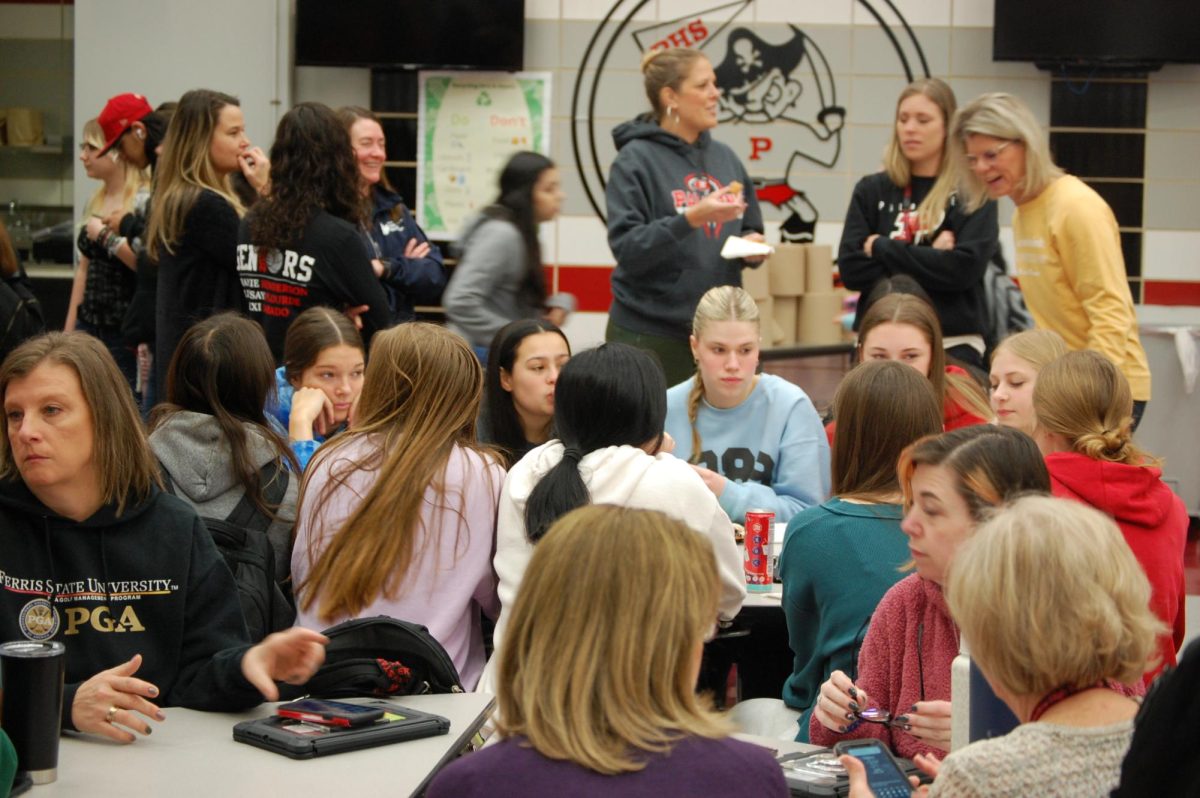 Former and current PHS female athletes fill the tables of the cafeteria to enjoy breakfast together.