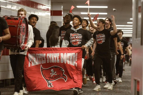 Members of the Palatine High School Boys Basketball Team cheer as they march down halls during the state send off