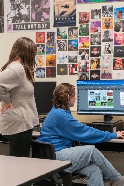 Seniors Natalie Steiger and  Madeline Herod make final edits on a yearbook spread. Their final deadline is tonight, March 22.