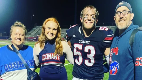 Mrs. Stary poses with her family at a recent Conant High School football game. 