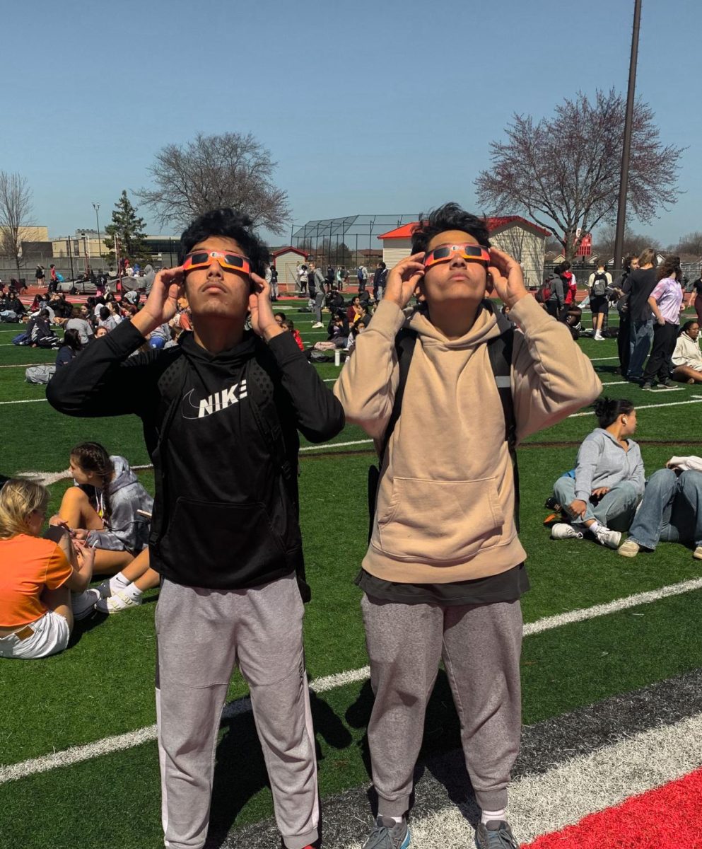Zayim yousuf (left) Krish handa (right) look up at the sun.
