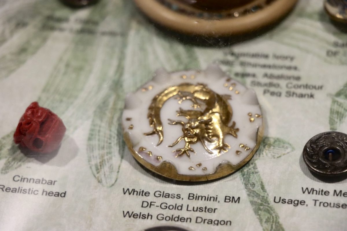 A Bimini white glass button depicts an image of a Welsh Golden Dragon.